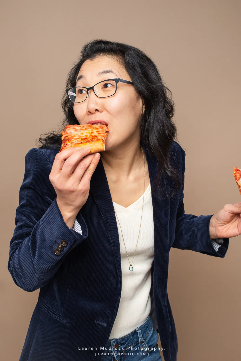 woman eating pizza headshot
